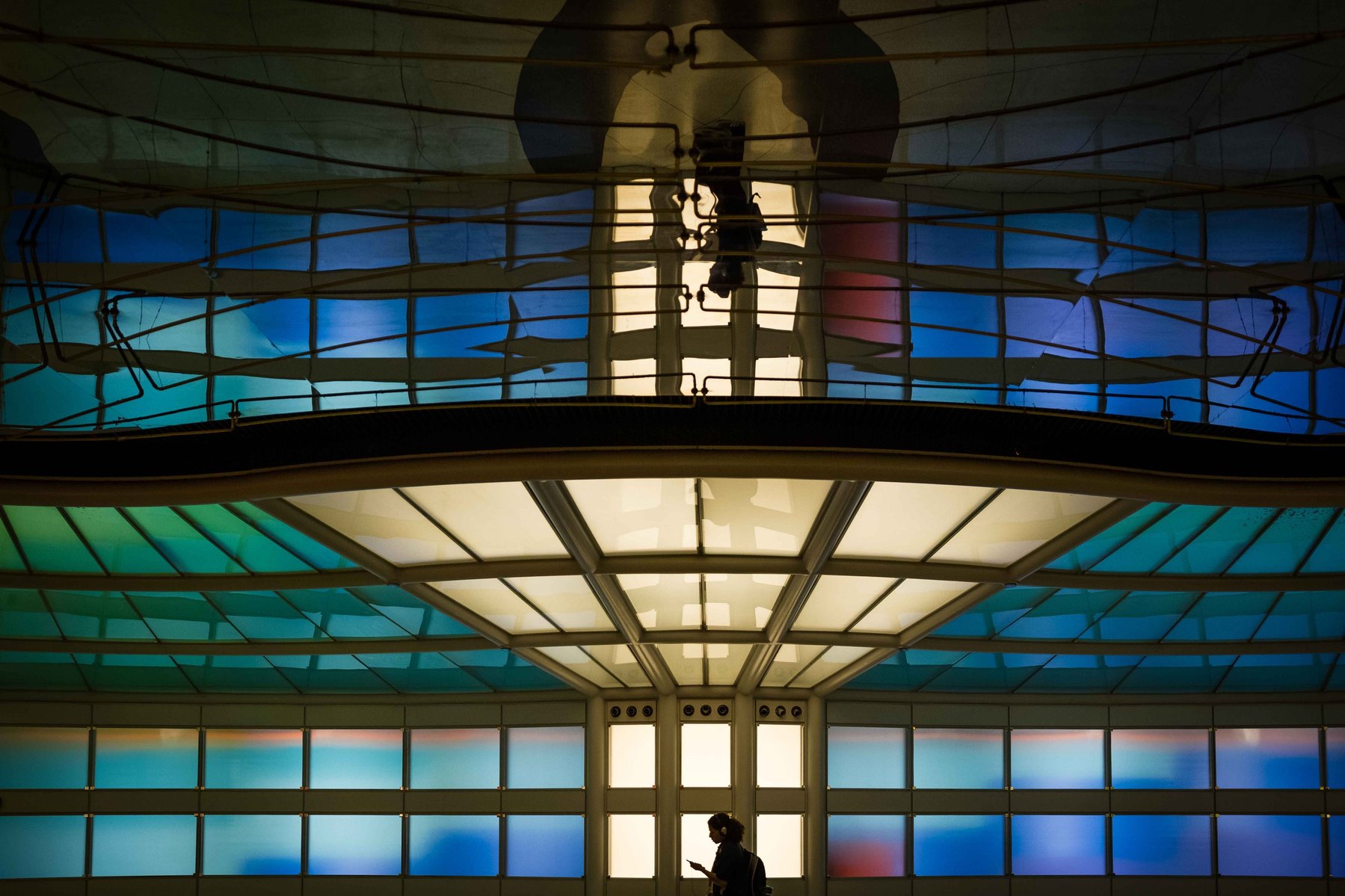 An image of a Chicago O'Hare airport hallway with a lone traveler standing in the middle.