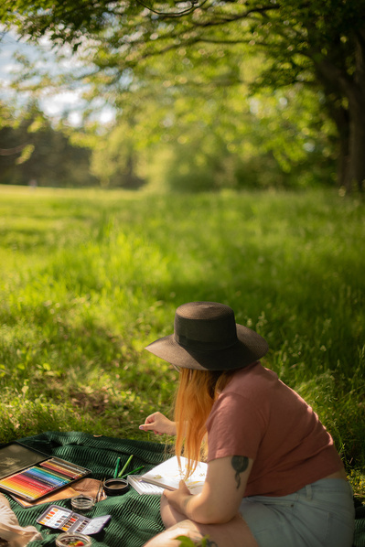 Femme faisant de la peinture dans un parc.