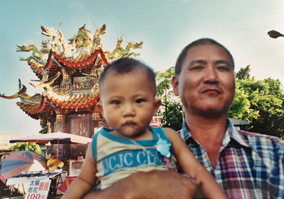 Photograph of Man with child (Ta-poo ga gín-á), Tainan, 1990s