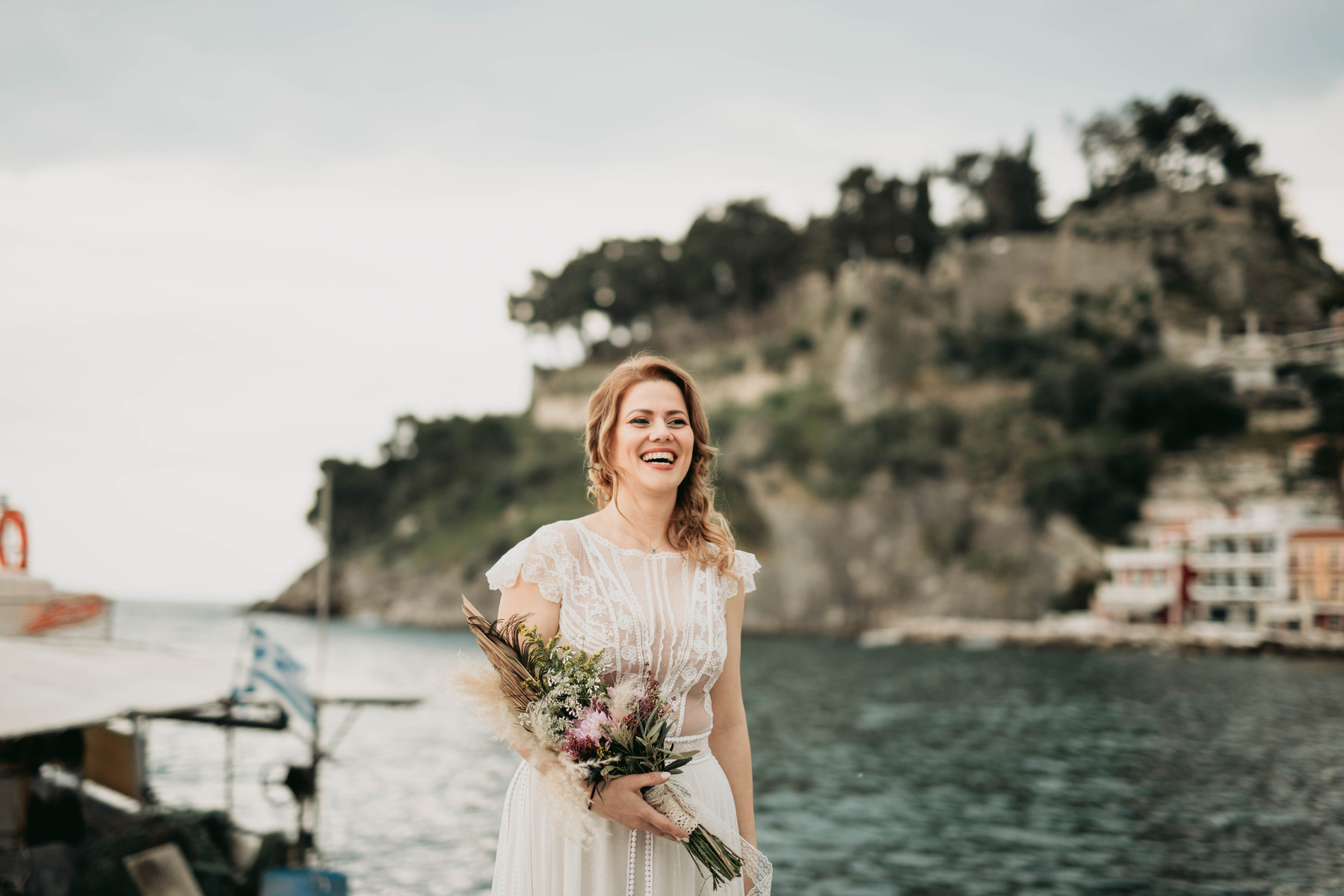 Bride with a flower bouquet, in the background the beautiful old castle of Parga in Greece.