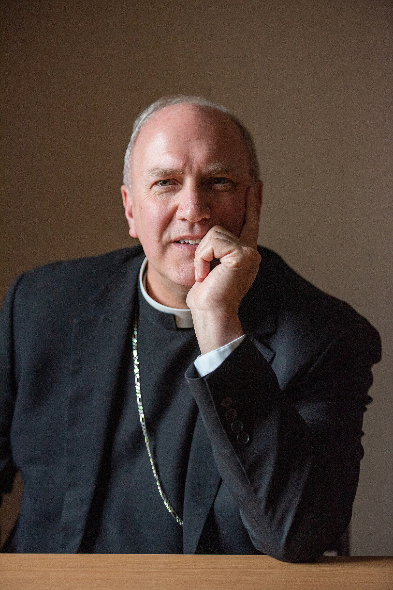 Jerry Vincke, bishop for the Diocese of Salina, sits at a table at the St. Isidore's Catholic Student Center.