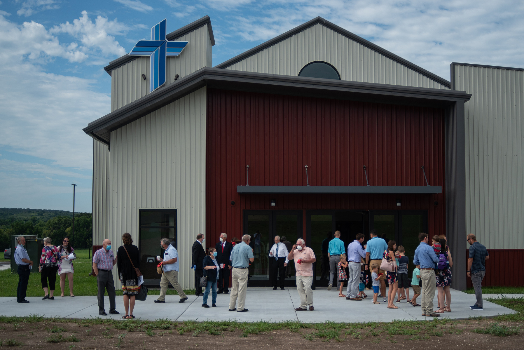 Church-goers talks outside St. Luke’s Lutheran Church following the service of dedication on Sunday.