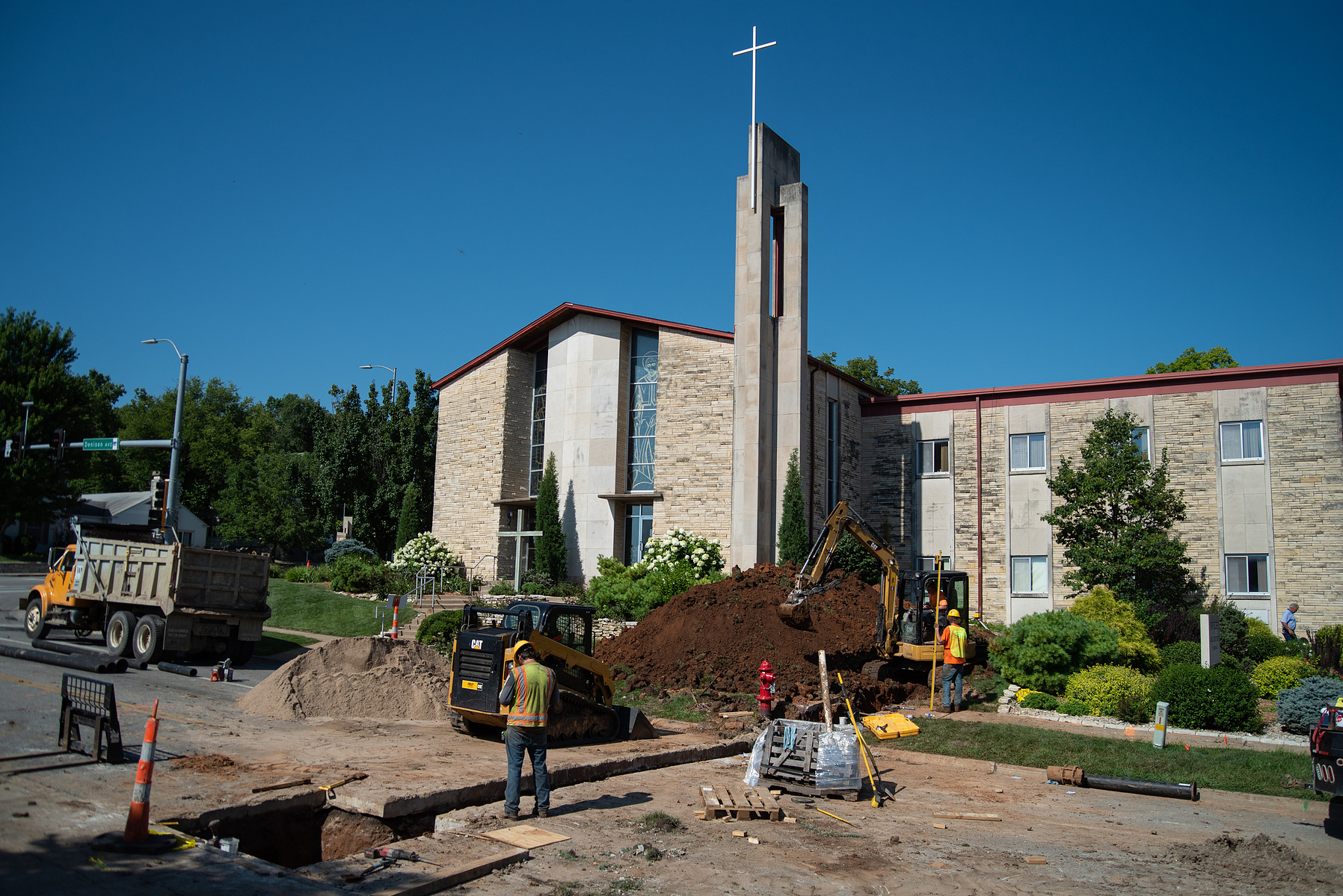 A bulldozer moves dirt in front of St. Isidore’s Catholic Student Center and Denison Avenue on Thursday. The construction will add an eight inch water mane for water and fire supply from Denison Avenue to St. Isidore’s.