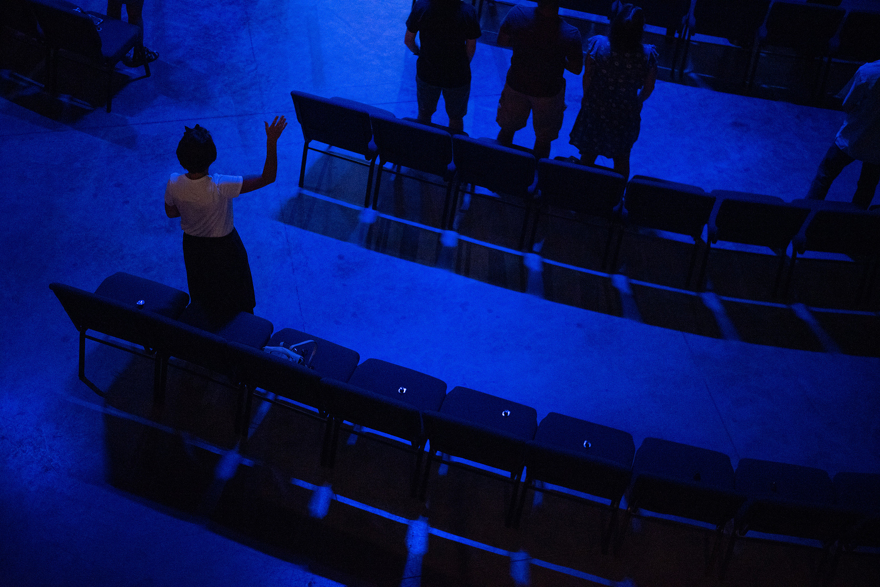 Kelly Pittman raises her hand during worship at University Christian Church on Sunday.
