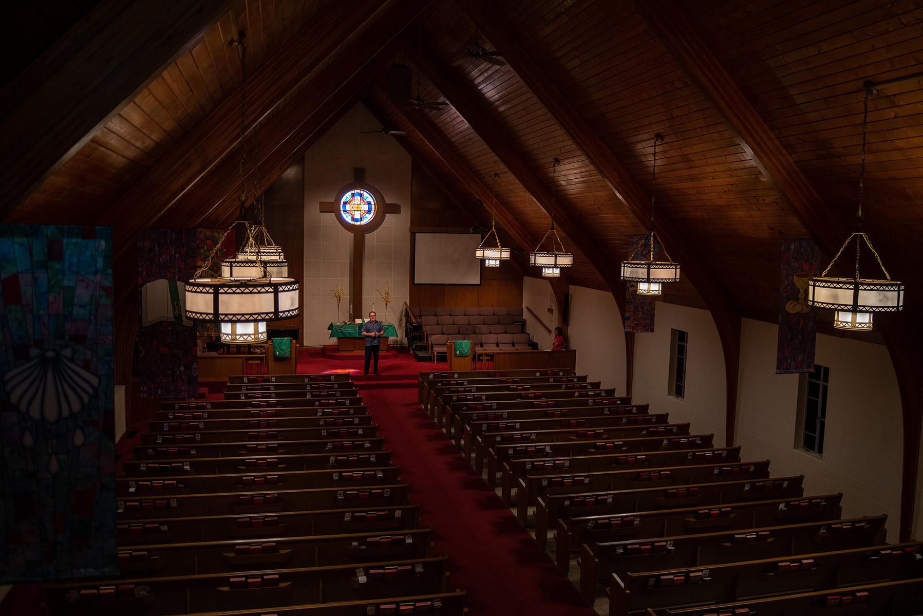 Pastor Dennis Ackerman preaches from the altar at College Avenue United Methodist Church on Sunday morning.