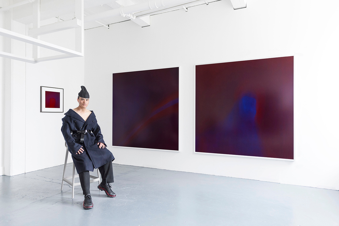 Tuck Muntarbhorn with his artworks