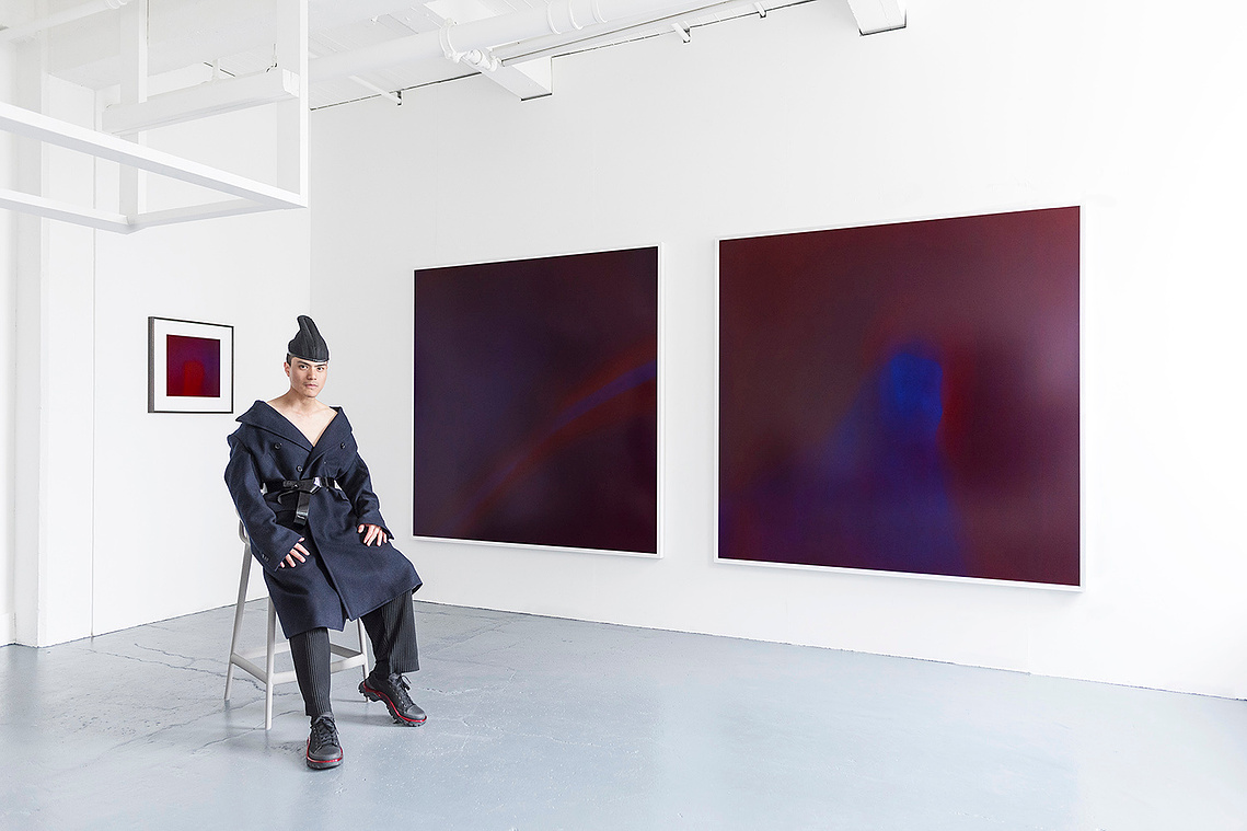 Tuck Muntarbhorn with his artworks