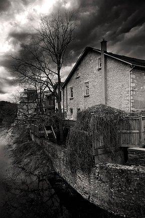 This striking photo features a historic stone building set against a dramatic, cloud-filled sky, showcasing architectural beauty and the interplay of light and shadow. Ideal for capturing Ontario’s rich history and rustic landscapes.