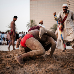 An intense and action-packed image of a traditional wrestling match, highlighting cultural heritage, athleticism, and raw energy. Perfect for showcasing cultural events, sports photography, and storytelling through visuals.