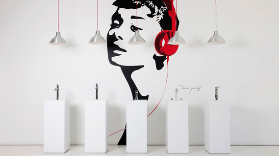 Commercial Interior photography showcasing custom sink faucets, lights and a vinyl of Audrey Hepburn