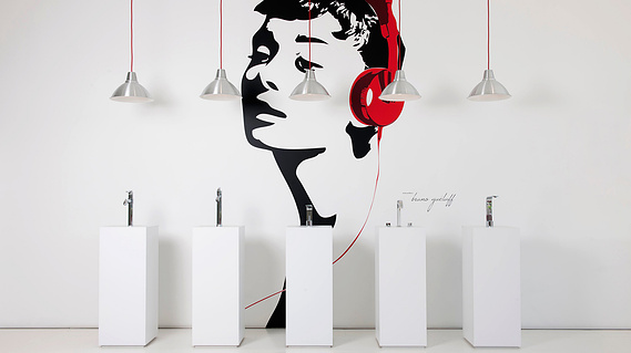 Commercial Interior photography showcasing custom sink faucets, lights and a vinyl of Audrey Hepburn