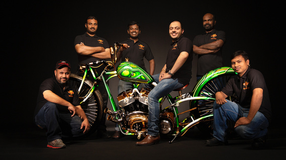 Commercial photography of a custom motorcycle built in dubai.  mechanics and designers on and around the bike