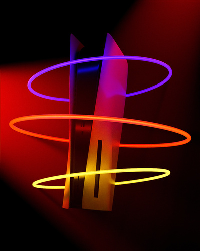 Made with CGI. A Playstation 5 hovering in a misty environment with three glow tubes around it. 