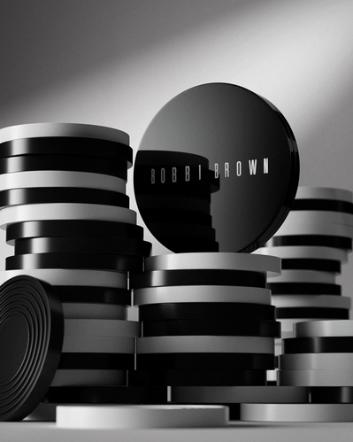 Made with CGI. A Bobbi Brown beauty compact sat on a pile of draught pieces.