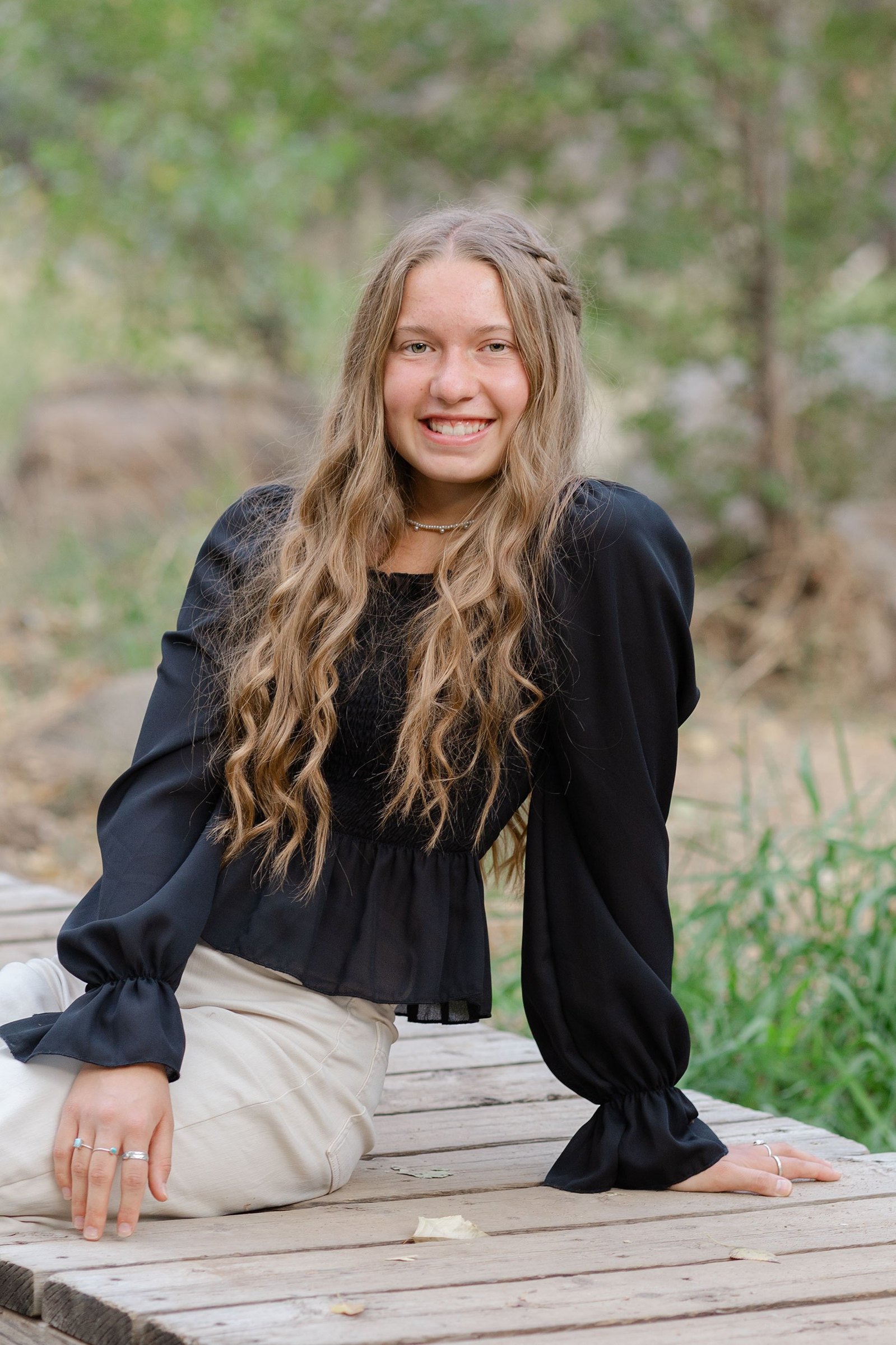 A senior photo session on a wooden bridge in Prescott, Arizona highlights the beauty and personality of the individual. 