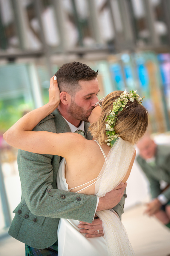 bride and groom kiss at Scotland Wedding event ceremony - Photography by Nate Cleary