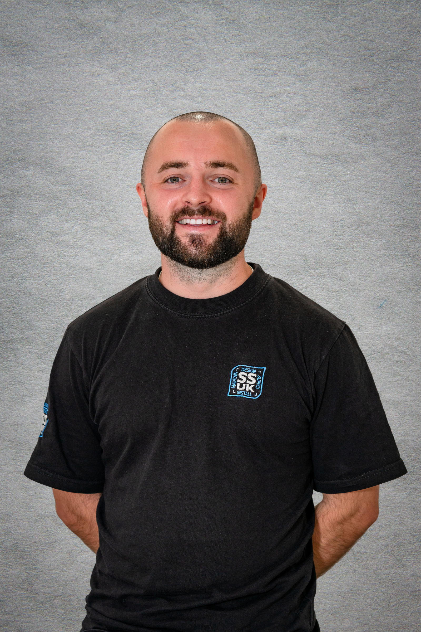 Scotland client posing for office headshots with studio light and background replacement in Glasgow - Photography by Nate Cleary