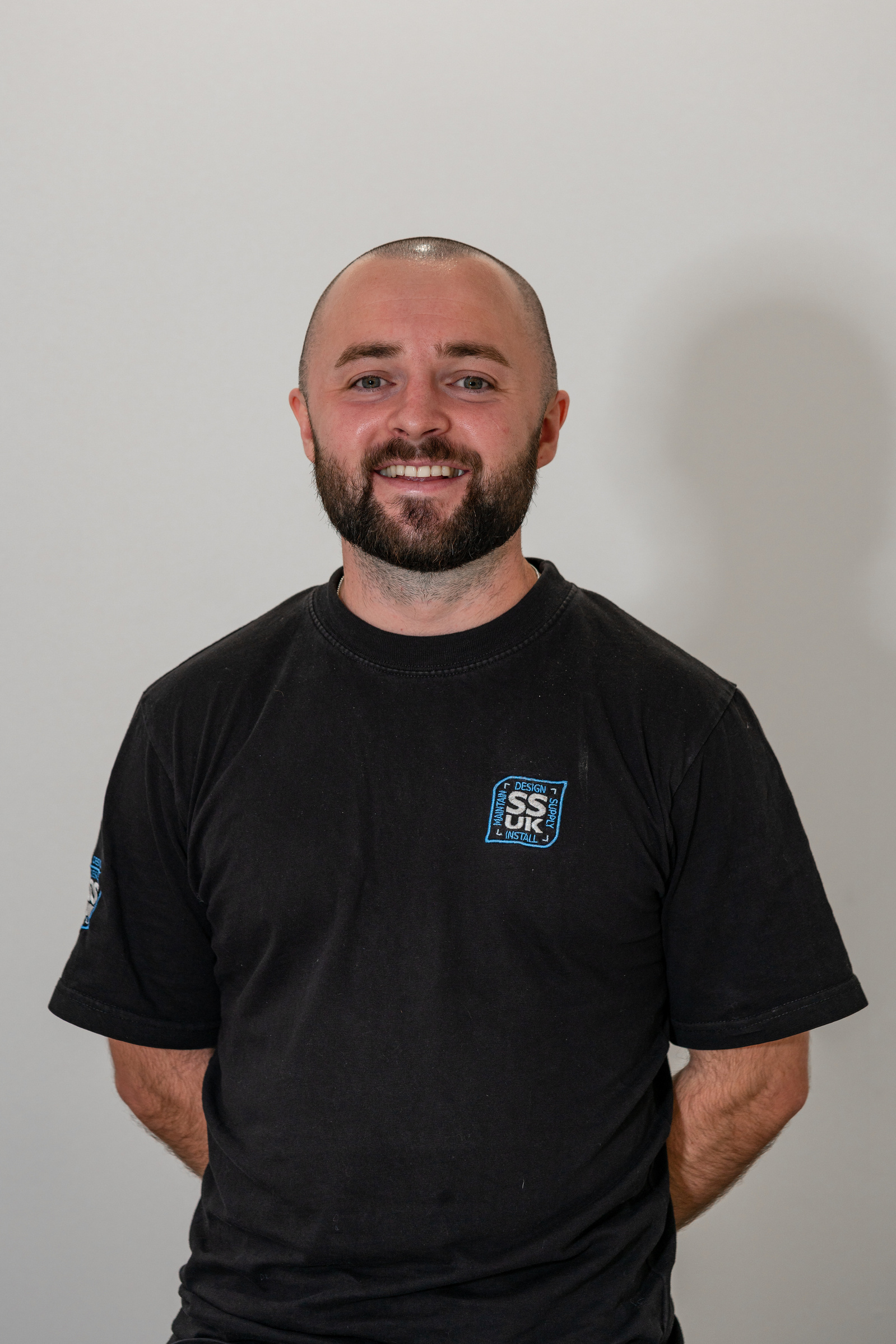 Scotland client posing for office headshots with studio light before background replacement in Glasgow - Photography by Nate Cleary