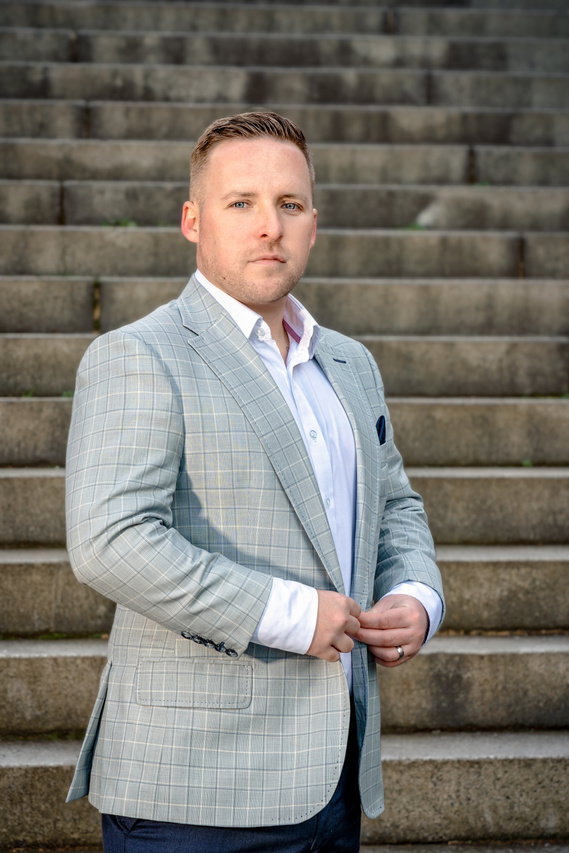 Scotland client posing for outdoor headshots with lighting at Kelvingrove Park in Glasgow - Photography by Nate Cleary