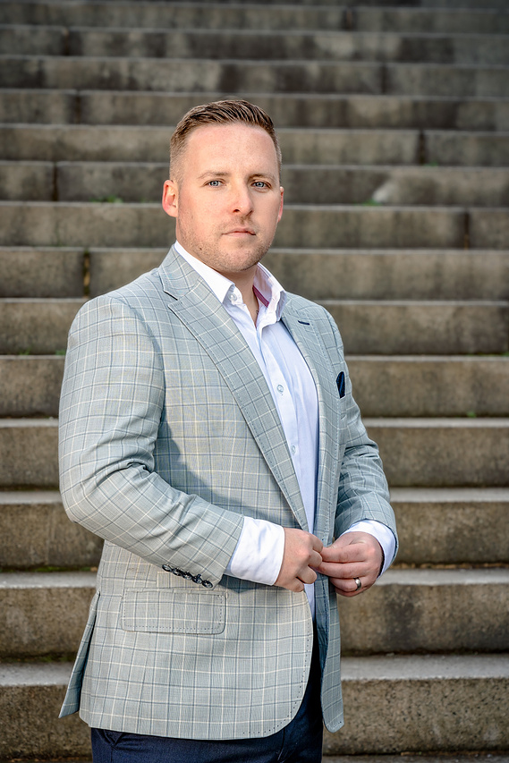 Scotland client posing for outdoor headshots with lighting at Kelvingrove Park in Glasgow - Photography by Nate Cleary