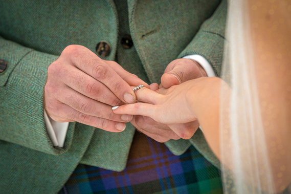 bride and groom exchange rings at Scotland Wedding event ceremony - Photography by Nate Cleary