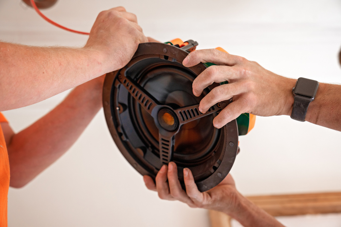 Scotland Commercial Photography of electricians installing speakers for Home Rewire - Photography by Nate Cleary