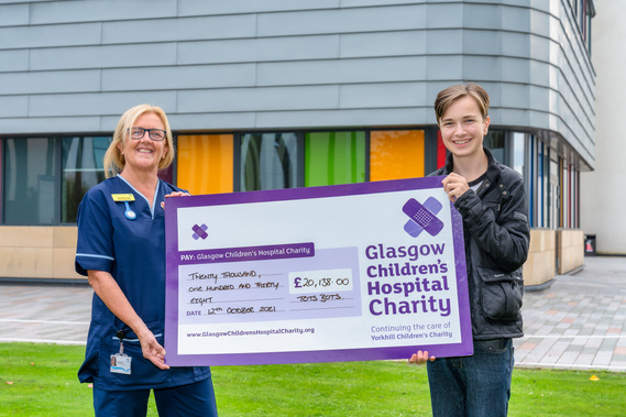 Patient and nurse posing with giant check for Glasgow Childrens Hospital Charity- Photography by Nate Cleary