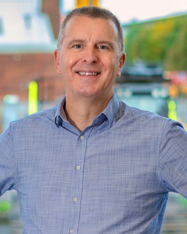 Scotland client posing for corporate headshots from Scot JCB - Photography by Nate Cleary