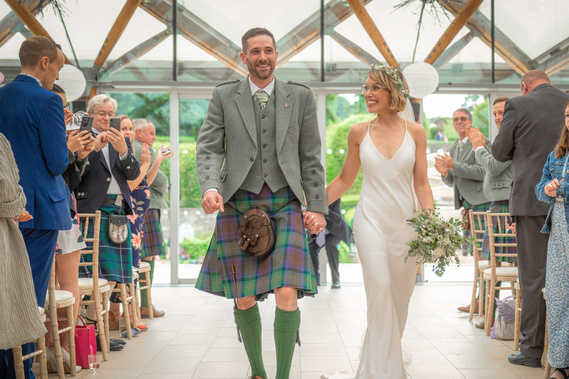 bride and groom walking down the aisle at Scotland Wedding event ceremony - Photography by Nate Cleary