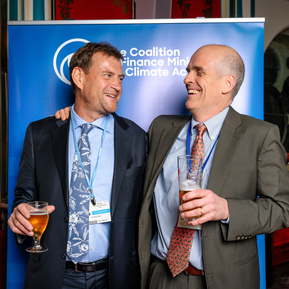 Guests for Worldbank Group pose in front of backdrop for event in Scotland- Photography by Nate Cleary