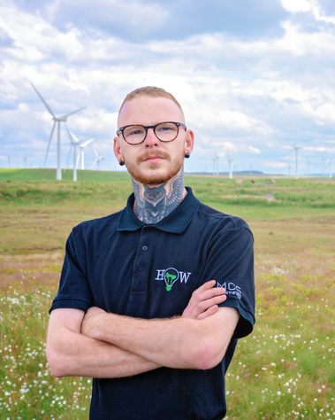 Scotland client posing for headshots from EnergyHow UK at Whitelee Windfarm - Photography by Nate Cleary