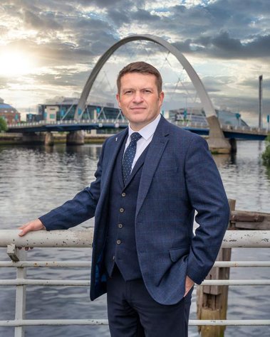 Glasgow client posing for corporate headshot from Revitalise Business Networking Group - Photography by Nate Cleary