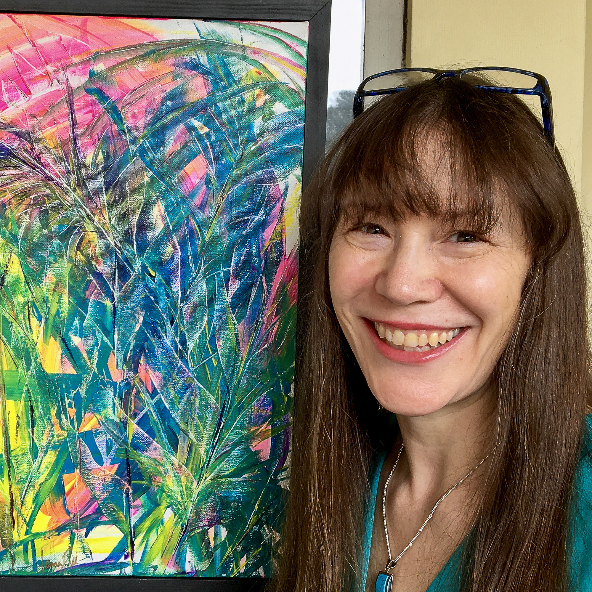 Headshot photo of Laura Dill with her painting 