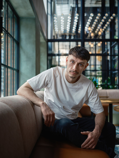 Portrait of actor writer comdian Richard Gadd on a sofa in a hotel in London.