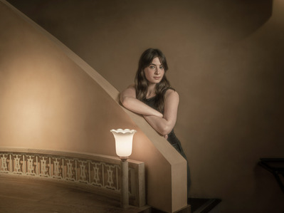 Painterly portrait of actor Agnes O'Casey on some stairs.