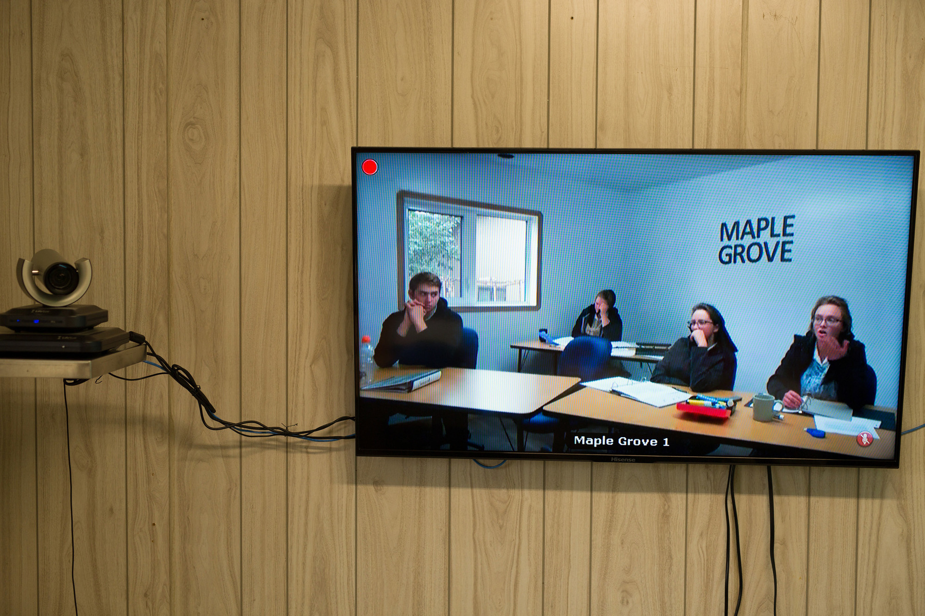 Hutterites students are seen on the screen of an ITV education system.