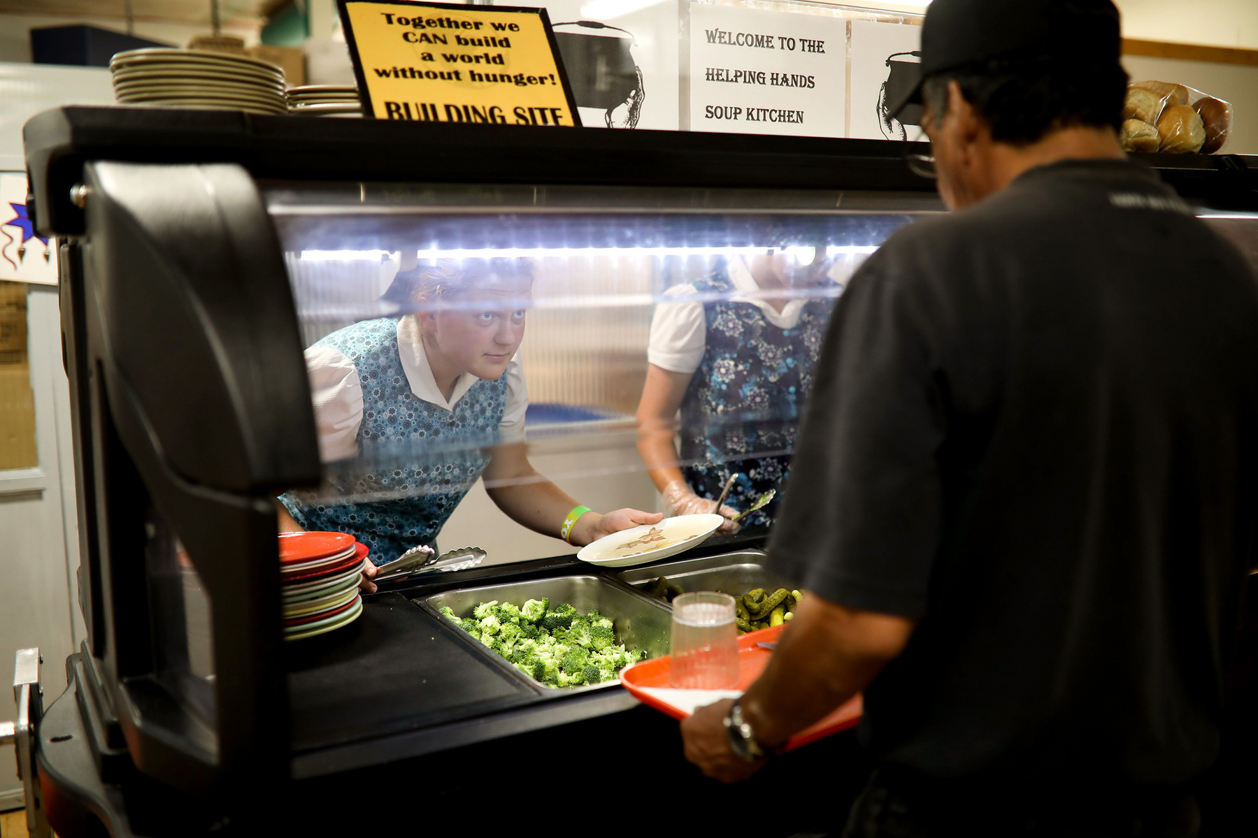 Hutterite women help serve lunch at a soup kitchen in Brandon, Manitoba.