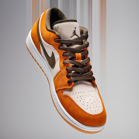 High-end product photography of a stylish sneaker with suede and leather details in earthy tones, suspended against a gradient background. Ideal for e-commerce, fashion branding, and commercial advertising in Arlington Heights and Chicago.