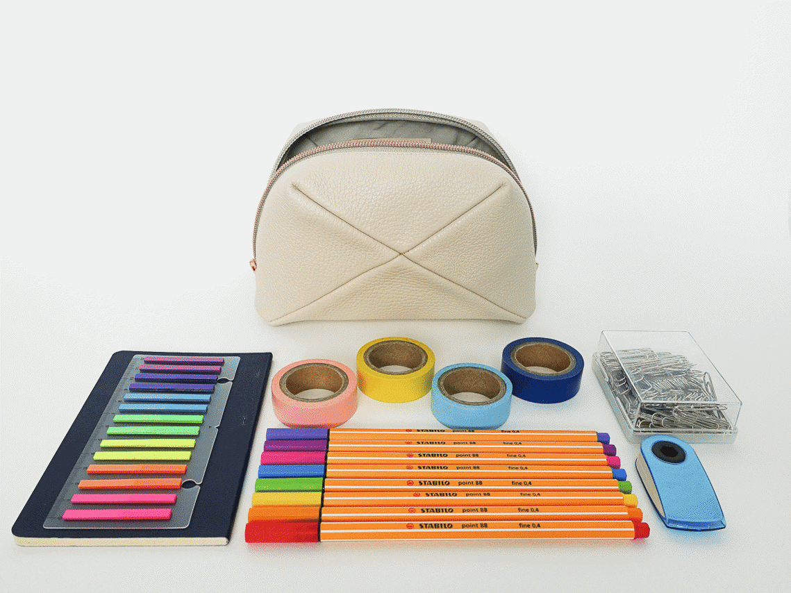 Stop motion video of the Stella pouch. Handcrafted beige leather pouch with a unique geometric design. Made in Delft, Netherlands. It features premium pebble grain leather and a rose gold zip. Perfect for storing beauty essentials or stationary