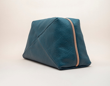 Handcrafted leather cosmetic bag with a unique geometric design. The Stella toiletry bag, made in Delft, Netherlands, features premium textured leather and a rose gold zip. Available in three colours. Made to order