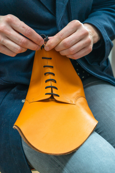 The derby boots are laced and ready to prelast. Burnt orange derby boots. Handmade, Italian leather