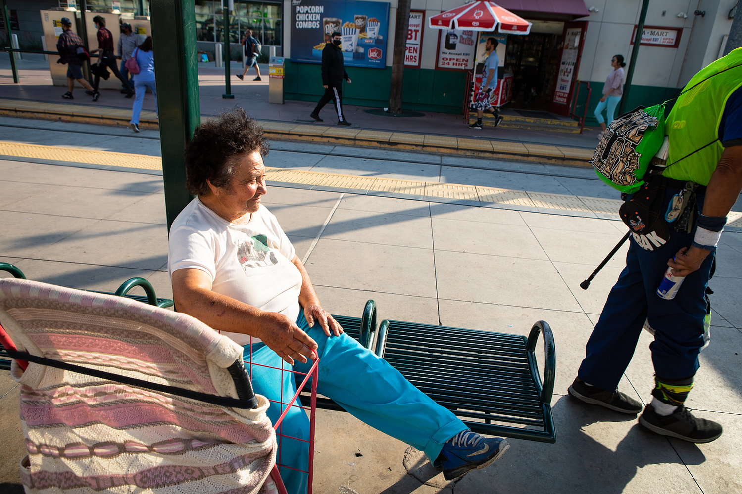 Eloisa Nuño sits on a bench at the San Ysidro Transit Center, June 17, 2021.