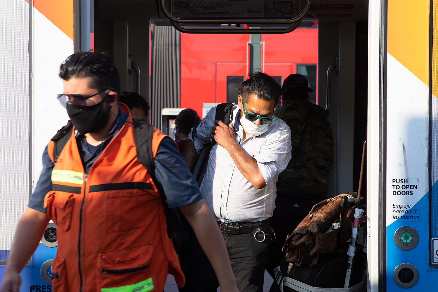 Riders exit a Blue Line trolley at the San Ysidro Transit Center, June 17, 2021.