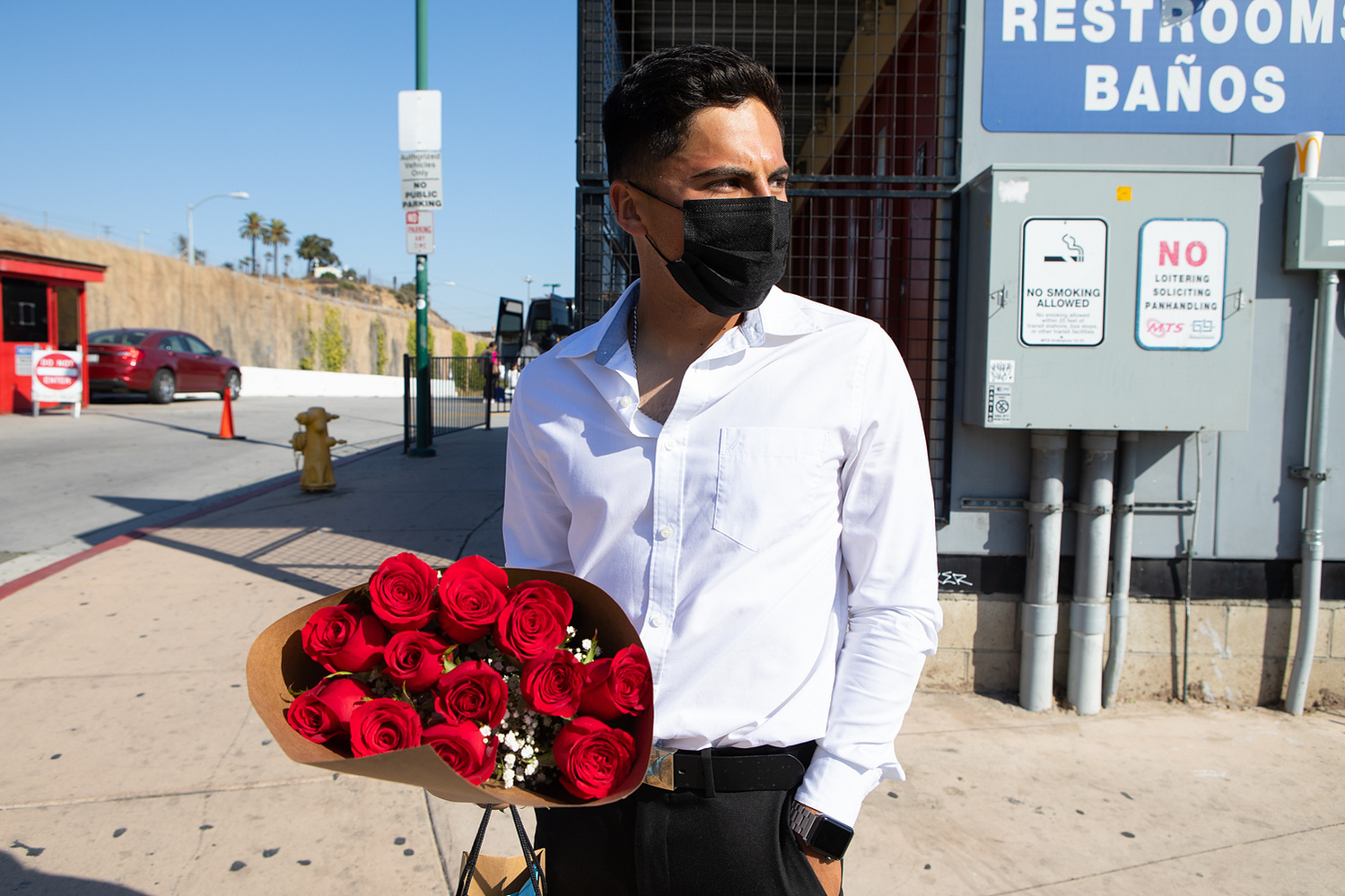 Emmanuel Alvarado waits for an Uber driver to arrive at the San Ysidro Transit Center, June 3, 2021. He was traveling from Tijuana to attend his girlfriend’s high school graduation.