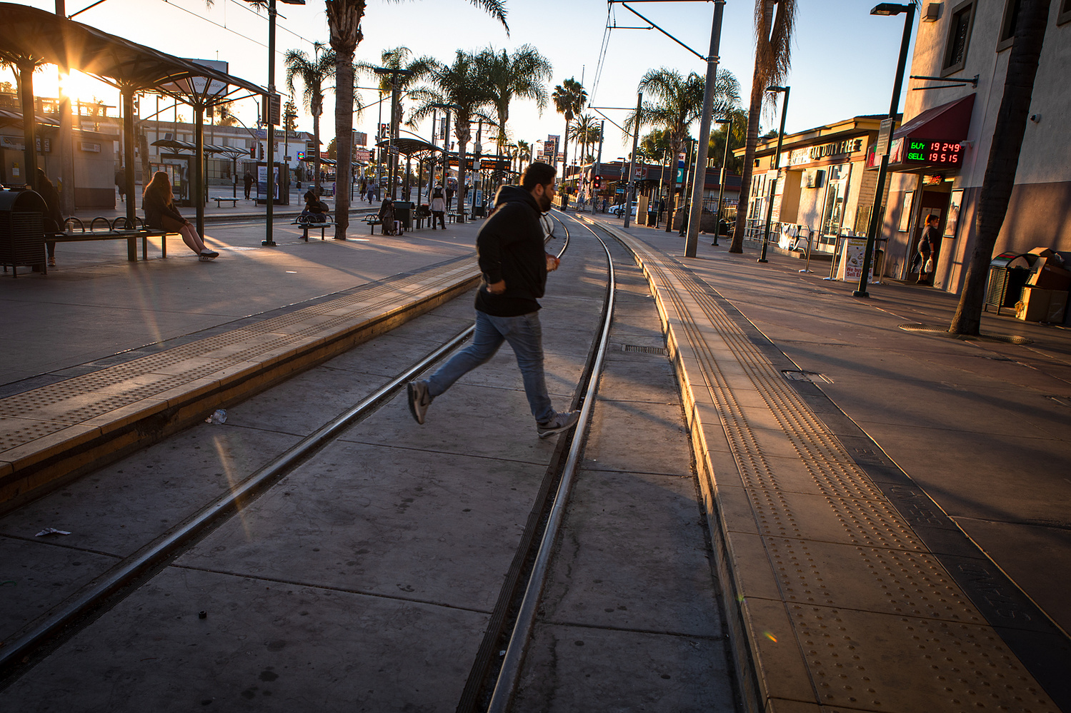 A man runs across the trolley tracks at the San Ysidro Transit Center, June 25, 2021.