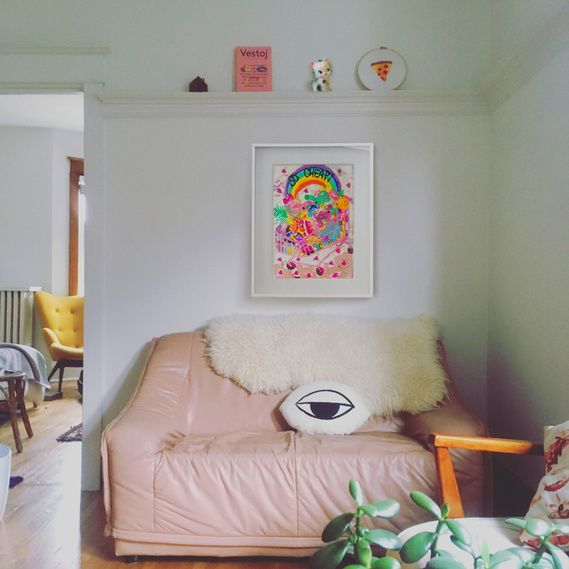 living room with pink sofa and painting of unicorns in a trolley by Fabi Santiago
