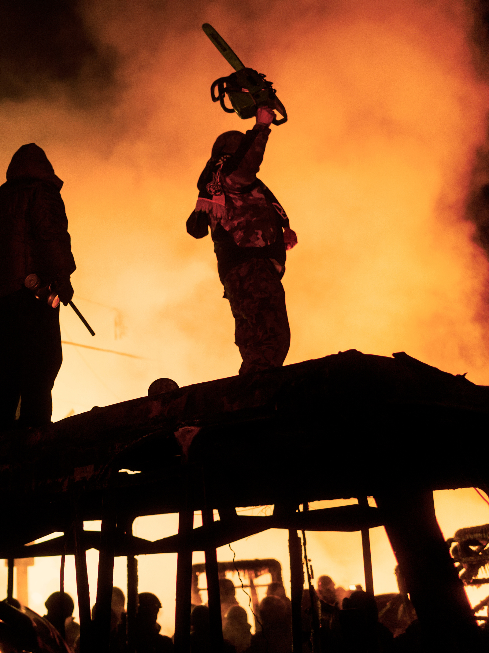Protesters fuel a fire barricade with tires during clashes between anti government protesters and riot police on Hrushevskoho street in Kiev. 24 January 2014