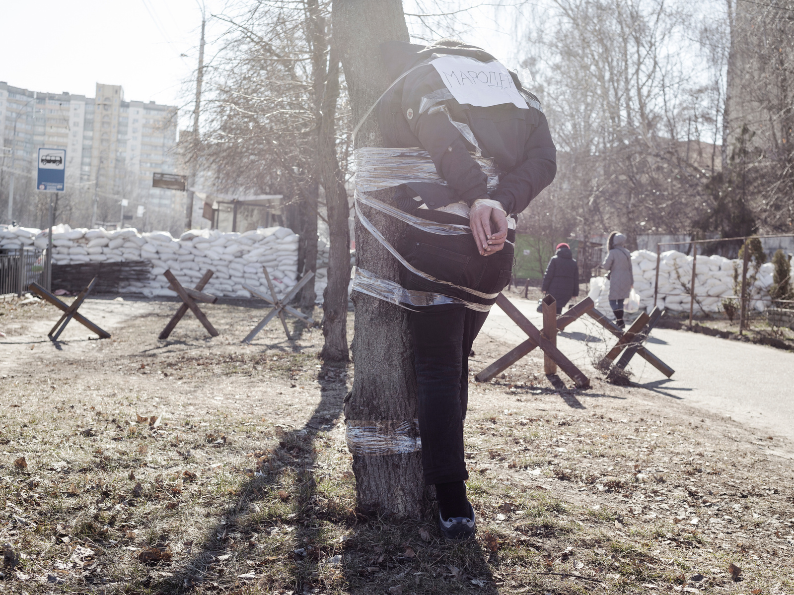 A man was caught shoplifting a chocolate bar in a grocery store. Citizens arrested him and tied him to a tree with a post "Thieft" on his back. Kyiv, Ukraine. 17 March 2022.