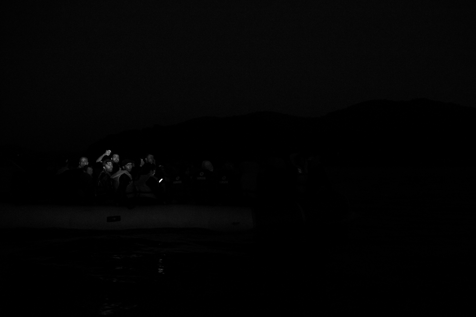 And inflatable boat crammed with refugees from Afghanistan and Syria arrive at night on the shores of Lesbos near Skala Sikaminias, Greece. With no lighting, no elementary navigation aides, the 9km distance to cross is perilous in case of engine failure o
