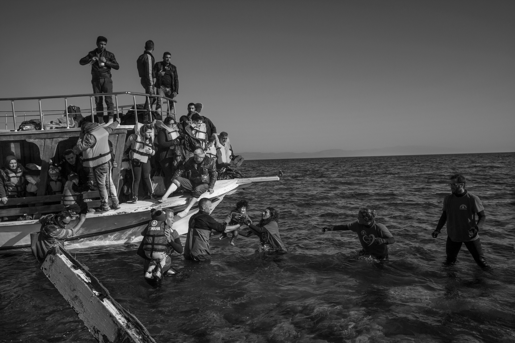 Refugees from Afghanistan and Syria disembark with help from volunteers on the shores of Lesbos near Molivos, Greece on 12 November, 2015. Lesbos, the Greek vacation island in the Aegean Sea between Turkey and Greece, faces massive refugee flows from the